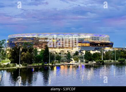 Optus Stadium lit in West Coast Eagles colours on the banks of the Swan River Perth Western Australia Stock Photo