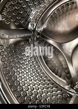 Washing machine- inside a washing machine- inside a washing machine drum - shiny steel - shiny metal- metal drum - clothes washing Stock Photo