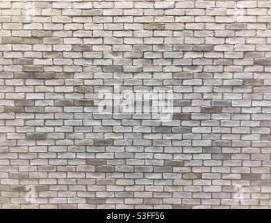 Light grey uneven brick wall. Stock Photo