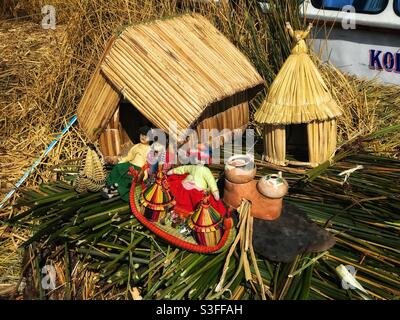 Models used as visual aids by a tour guide explaining how the floating islands of Uros in Lake Titicaca are made and how the inhabitants live Stock Photo