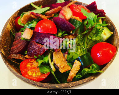Salad with vegan kebab pieces in a coconut bowl Stock Photo