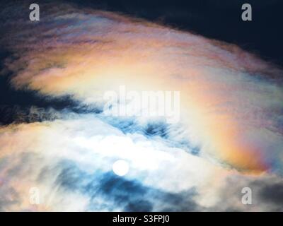 Rainbow coloured clouds fill the sky. Stock Photo