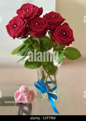 Pink angel soy wax candle and beautiful diamanté Pearl red rose bouquet Stock Photo
