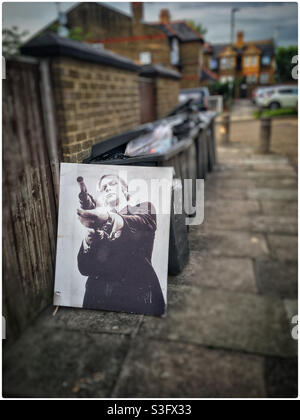 Michael Caine art canvas dumped by bins Stock Photo