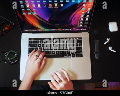 Hands on laptop, working and studying remotely from home, TopView female hands Stock Photo