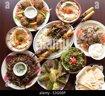 Food, Middle Eastern cuisine plated, TopView table top or Bunton’s falafel, Lamb, tabouli, grape leaves Stock Photo