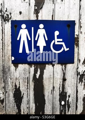 Mixed gender toilet sign for women gents and disabled with copy space Stock Photo