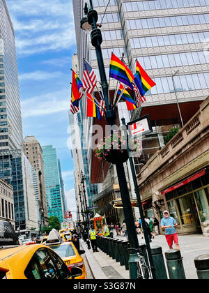 Gay pride rainbow flags in American flags on display in front of Grand Central terminal on E. 42nd St. in Midtown Manhattan, NYC, USA Stock Photo