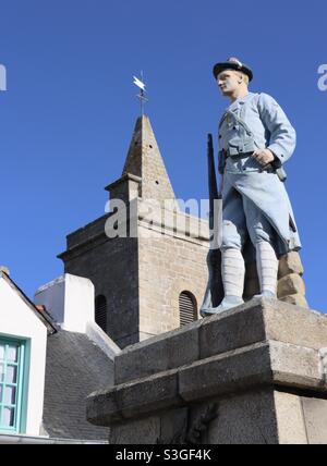 The church of Houat island and the statue of the marine rifleman in memory of the islanders who died for France during the two world wars , in Brittany, Morbihan Stock Photo