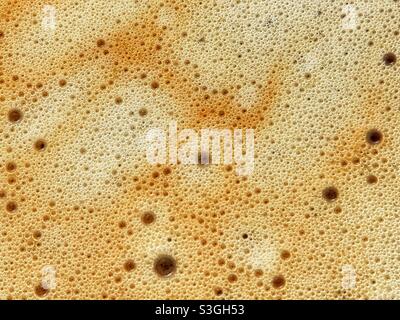 Close -up view of bubbles of different sizes on the froth of a freshly brewed coffee Stock Photo