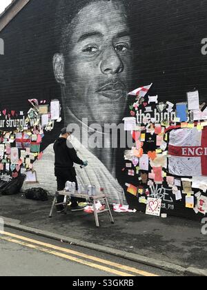 Close up of a small part of the giant Manchester United player Marcus  Rashford mural in Withington, Manchester, England, United Kingdom, that was  vandalised with abusive graffiti after England's Euro2020 football loss