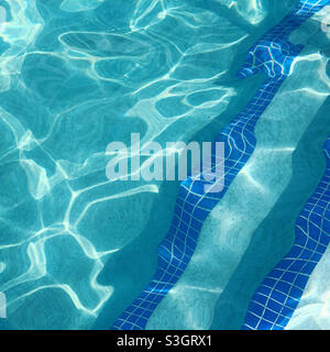 Sunlight reflecting on the surface of a pool at a resort Stock Photo