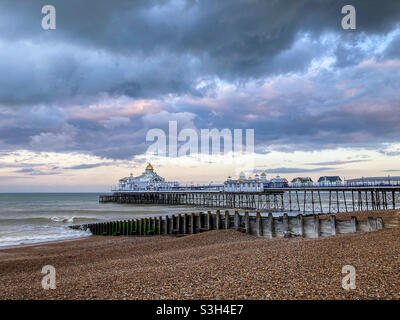 Eastbourne pier in East Sussex on a cloudy summer evening shortly before a torrential rain downpour Stock Photo
