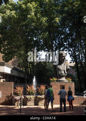 4 tourists looking at the Benjamin Franklin bust at the Philadelphia fire station on Arch Street, in the old City Stock Photo