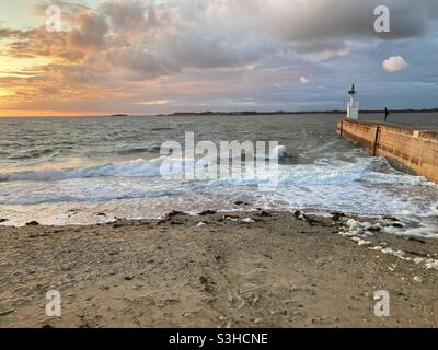Sunset and waves at the Pointe de Merquel in Loire Atlantique, Brittany, France Stock Photo