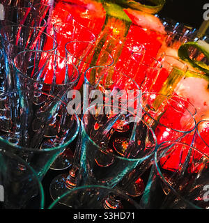 Flute glasses backlit by sparkly Christmas decorations Stock Photo