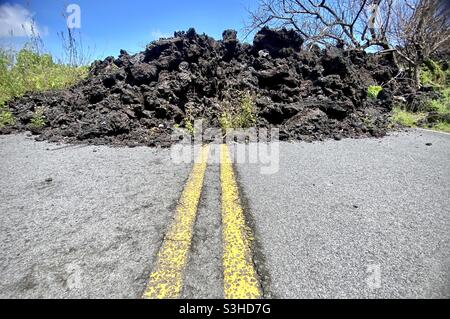 Lava, now solidified, that flowed over and blocked a road in Isaac Hale Beach Park (known locally as Pohoiki) in the Puna Region of the Big Island of Hawaii after the 2018 eruption of Kilauea Stock Photo