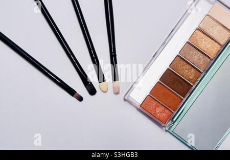 Four kind of brushes and eyeshadow palette Stock Photo