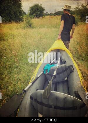 Carrying the kayak to the water Stock Photo