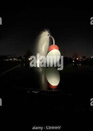Spoonbridge and Cherry sculpture and fountain at night by Claes Oldenburg and Cloosje van Bruggen. Minneapolis Sculpture Garden, part of the Walker Art Center. Minneapolis, Minnesota, USA. Stock Photo