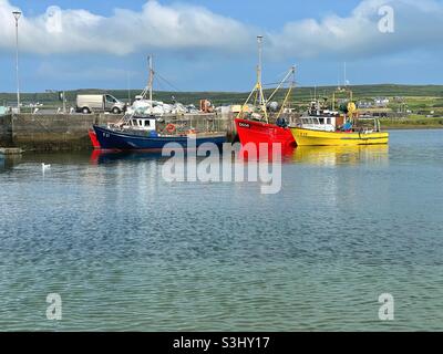 Port Magee harbour with moored fishing boats, Valentia island in the background, County Kerry, Ireland, August. Stock Photo