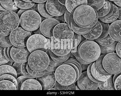 A pile of British 2 pence coins. A familiar sight in games arcades where slot machines are played. The 2p coin features a portrait of Queen Elizabeth II and a plume of feathers. Pic ©️ COLIN HOSKINS. Stock Photo
