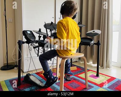 Little boy playing on an electric drum kit Stock Photo