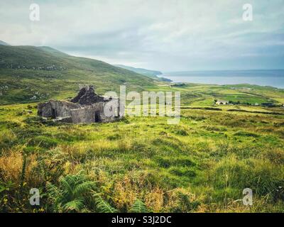 Abandoned old stone cottage overlooking the sea on the coast of County Kerry, Ireland, August. Stock Photo