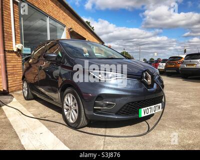 Brand new 71 registration Renault Zoe electric car being recharged on the dealers forecourt September 2021 Stock Photo