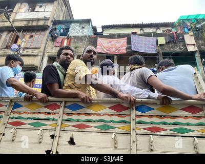 Labours are travelling in a small vehicle in Kolkata Stock Photo