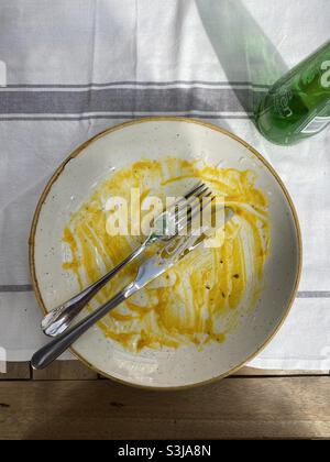 An empty plate - the meal is eaten and the food has been enjoyed. All that is left is a small amount of butternut sauce. Photo ©️ COLIN HOSKINS. Stock Photo