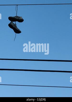 Electric wires hanging on a pole with a lighting lamp photographed from ...
