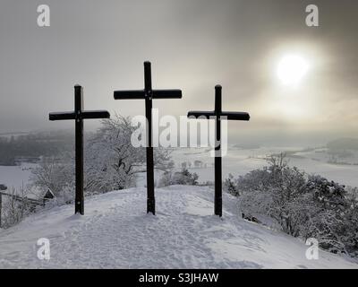 Summit crosses on a hill (Kornbühl) in scenic winter landscape with lots of snow in the Swabian Alps Stock Photo
