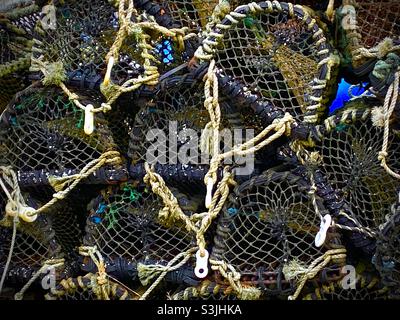 Close up of a stack of empty lobster pots with ropes used for sea fishing in boats Stock Photo