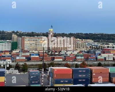 Building with logo sign outside the headquarters of the Starbucks Coffee Company in Seattle, Washington, USA. View from the merchant cargo ship moored in container terminal. Stock Photo