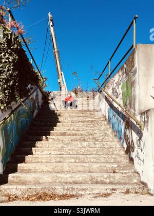 Boy child sitting on stairs, suburban feeling Stock Photo