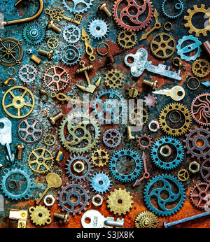 Metallic flat lay on rusty background, featuring cogs, nuts, bolts, keys, screws etc... Stock Photo