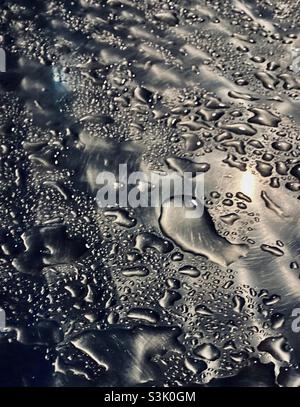 Raindrops on a metallic surface Stock Photo