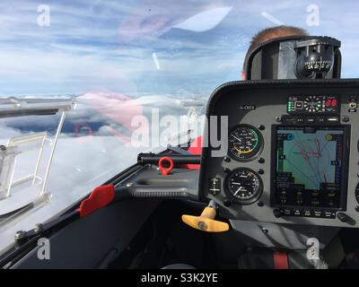 Schempp-Hirth Duo Discus glider above wave clouds. View from back seat, with instruments 7600’ Stock Photo