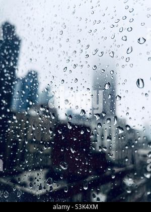 Raindrops on a window with a blurred background of Skyscrapers In New York City Stock Photo