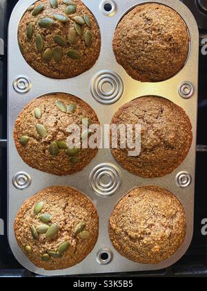 Oat bran muffins with pumpkin seeds, straight out the oven. Stock Photo