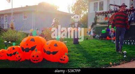 Freddy Kruger and ghostly friends, goblin and jack o lanterns occupy a front lawn awaiting Hallowe'en night Stock Photo