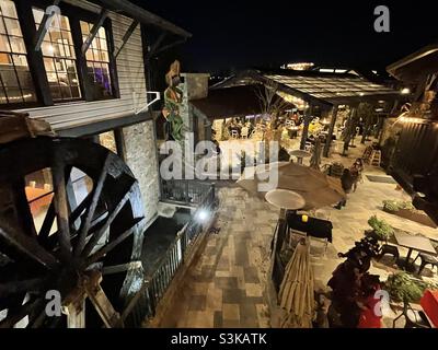 A semi-aerial view looking down over the plaza and patio area of the restaurant at Gardner Village, Utah, USA during its’ annual “WitchFest”. A working antique waterwheel can be seen on the left. Stock Photo