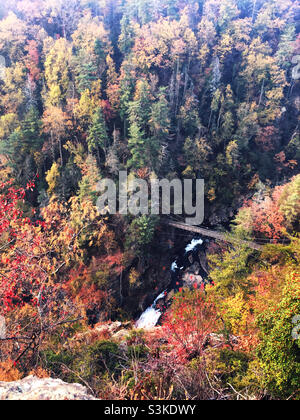 Scenic view at Tallulah Falls State Park looking down into the canyon. A suspension bridge crosses the river and falls. Stock Photo