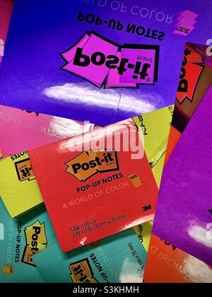 Multiple images of multi-colored post-it pop-up notes have been merged and overlapped to create this colorful office-themed abstract. Stock Photo