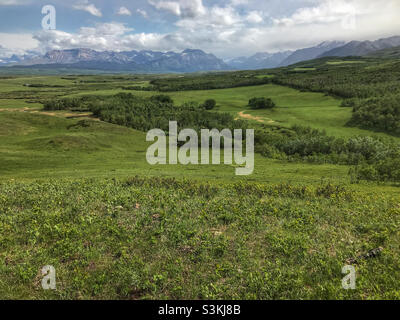 Looking south towards the Rocky Mountains along the Canada/US border, from the viewpoint near Twin Butte in southern Alberta, Canada - where the mountains meet the prairies. Stock Photo