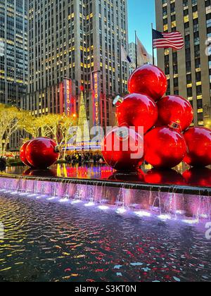 2021, giant Christmas tree ornaments piled high in a reflecting pool at 1251 Avenue of the Americas across from radio city music Hall during the holiday season, NYC, USA