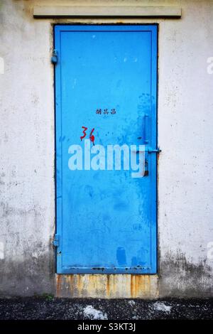 Painted metal door, Tai O, Lantau Island, Hong Kong Stock Photo