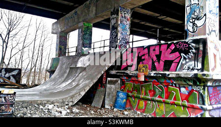 Skate ramp has been built under a bridge and street art has covered the cement in Cleveland Ohio.     Photo taken on May 20,2021 Stock Photo