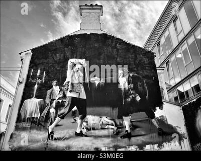 “The Duel of Belfast. Dance by Candlelight.” The famous and iconic artwork created by Conor Harrington & painted on the side of a building in Hill Street, Belfast, N. Ireland. Photo ©️ COLIN HOSKINS. Stock Photo